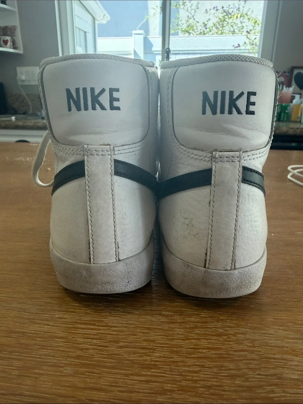 Nike White High-Top Sneakers with Black Swoosh and Red Logo